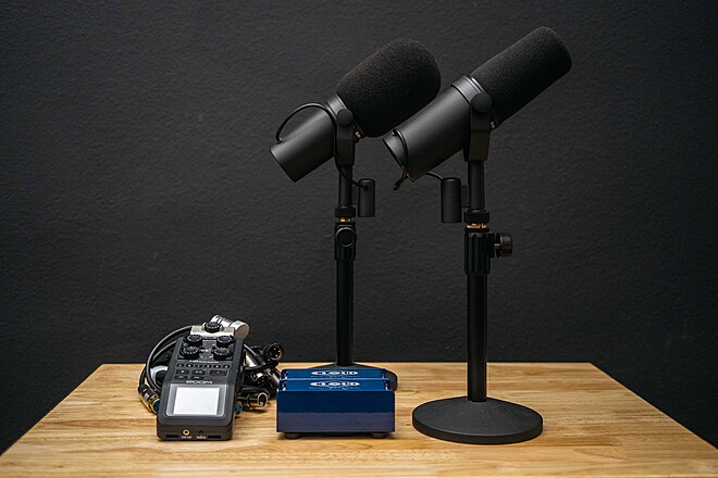 Pair of Shure SM7B presenter microphones with studio audio equipment