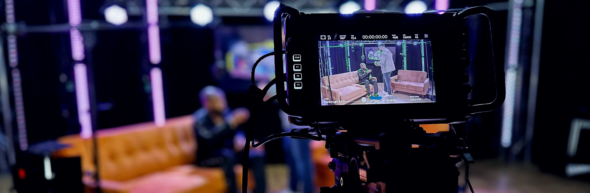 Professional camera filming a presenter in the moody, broadcast-lit Podcast Studio Leicester